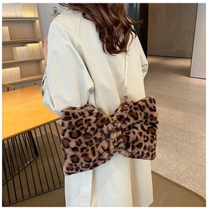 Detail of leopard print plush bow bag with elegant faux pearl chain strap for women