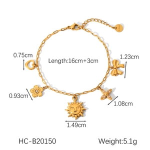 Detail of gold paperclip chain bracelet with heart, flower, and sun charms and dimensions