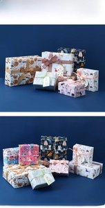 Detail of colorful cartoon cat and dog gift wrapping paper with ribbons and tags