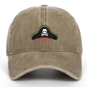 Close-up of pirate skull embroidery on washed cotton khaki vintage baseball cap