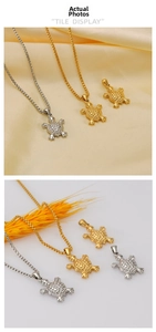Detailed close-up showing 18K gold and silver turtle pendants with embossed shell textures