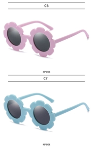 Detail view of pink and blue sunflower shaped sunglasses for kids with matte frames