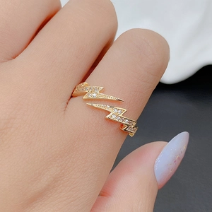 Close-up of gold lightning bolt ring with sparkling pavé cubic zirconia stones