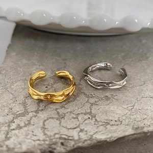 Detailed view of gold and silver irregular textured S925 sterling silver open rings