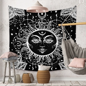 Detail of bohemian black and white sun and moon mandala tapestry on industrial wall