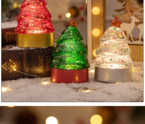 Close-up of LED Christmas tree night lights with glitter filling on artificial snow