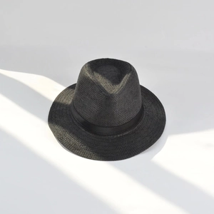 Detailed top view of black woven straw fedora hat showing fine texture and ribbon