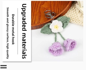 Macro shot of handmade crochet flower keychain with purple lilies and silver metal hook