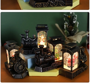 Close-up of vintage Christmas train lantern featuring a rotating snowman and festive LED glow