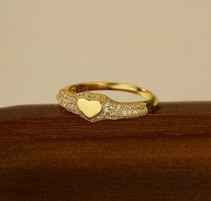 Macro view of gold S925 silver heart ring with sparkling pavé micro-inlaid zircon