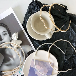 Detail of elegant gold and silver metal headbands with pearls and sparkling rhinestones
