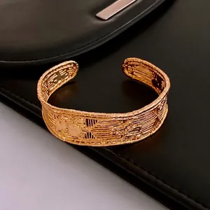 Vintage gold plated mesh cuff bracelet with ornate embossed textures on black leather