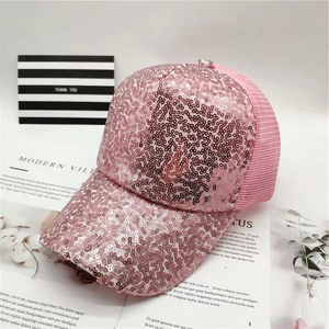 Detailed shot of pink sequin baseball cap with breathable mesh back on decorative props