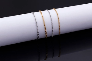 Detail of delicate gold and silver stainless steel cross chains on white display