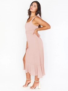 Elegant light pink midi dress with bow shoulder straps and ruffled slit hemline