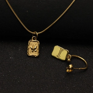 Detailed view of golden butterfly pendant and Beauty engraving on the metal surface