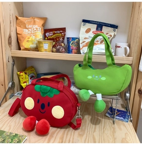 Detail of red tomato and green pea pod canvas bags with cute 3D plush legs and embroidery