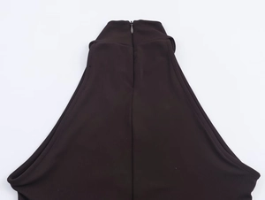 Detail of invisible back zipper closure on dark brown halter neck dress with knit fabric