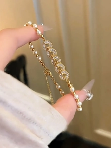 Detail of elegant pearl bracelet featuring gold alloy beads and zircon inlaid rings