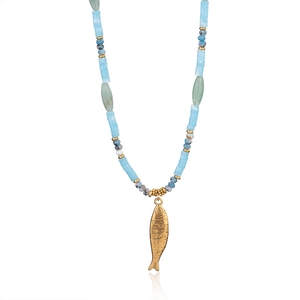 Detailed shot of the blue and green stone beaded necklace with a gold fish charm