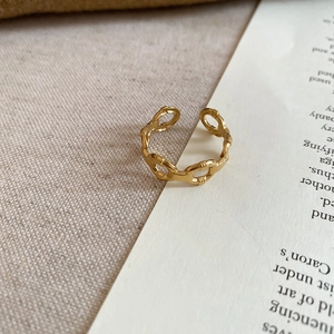 Detailed close-up of a gold-plated heart ring featuring an adjustable bamboo chain design