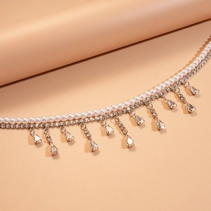 Detail of layered necklace with white imitation pearls and water-drop crystal tassels
