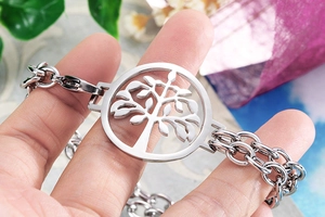 Macro detail of Tree of Life pendant on silver double-layer stainless steel chain