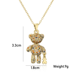 Close-up of golden teddy bear pendant with multicolor zircons and size dimensions