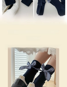 Detail of navy blue ribbed socks with a blue and white checkered bow ornament