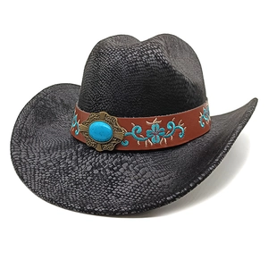 Detail of black cowboy hat featuring snakeskin texture and turquoise gemstone inlay