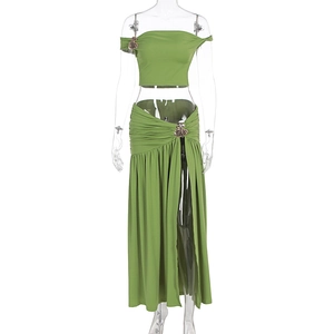 Detail of clover metal buckle on grass green off-shoulder cropped top and maxi skirt set