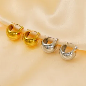 Chic 18K gold and silver plated spherical hoop earrings on champagne silk background