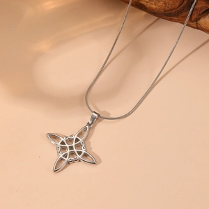Close-up of silver stainless steel witch knot pendant with intricate hollow design