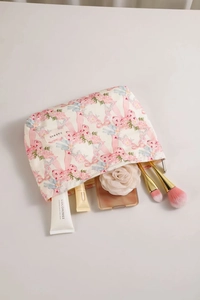Close-up of floral cotton cosmetic bag with pink bows showing large interior capacity