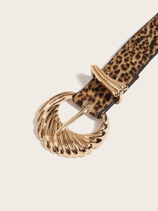Close-up of leopard print skinny belt with a textured golden seashell-shaped metal buckle