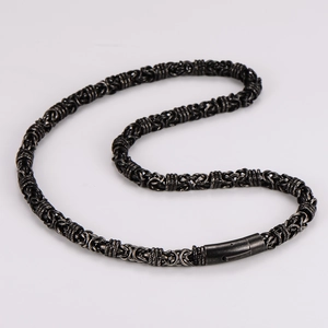 Close-up of black stainless steel woven curb chain necklace with secure clasp closure