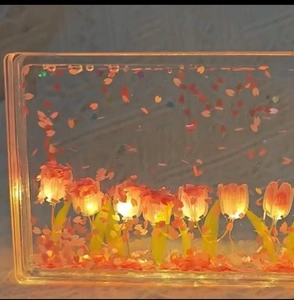 Detailed macro view of acrylic night light featuring glowing tulips and pink petals