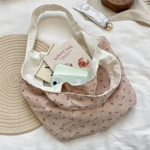 Flat lay of pink floral corduroy tote bag showing large capacity and thick canvas lining