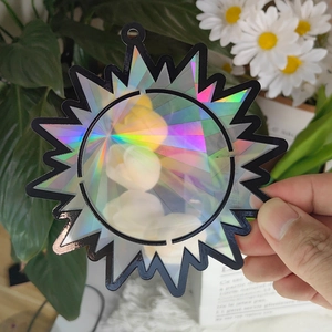 Detailed holographic sun catcher pendant with a black frame reflecting rainbow light