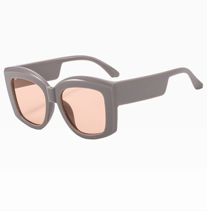 Detail view of taupe square sunglasses with thick temples and orange tinted lenses