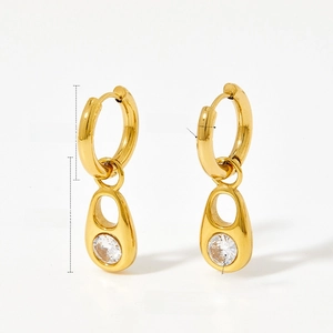 Detail of gold oval hoop earrings with sparkling zircon pendant and 39mm length