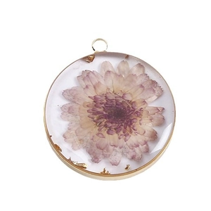 Handmade resin dried flower pendant with purple daisy in a gold circular frame