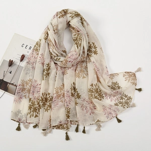 Detailed close-up of floral print cotton-linen scarf with delicate fringe tassels