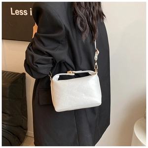 Detailed side view of white faux leather crossbody bag with rich rabbit embossed text