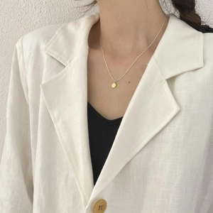 Elegant 925 sterling silver coin pendant necklace styled with professional linen blazer