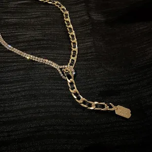 Exaggerated golden curb chain and rhinestone necklace featuring a Good Luck engraved pendant
