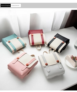 Multiple mini square backpacks in pastel colors displayed on a white cafe table scene
