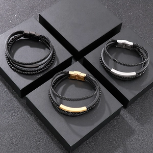 Macro view of multi-layer braided leather bracelets with gold, silver, and black metal clasps