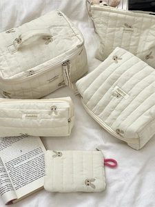 Quilted cream storage bag set with rabbit embroidery including pouches and cases