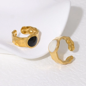Detail of gold-plated 18K titanium steel rings with black and white enamel inlay